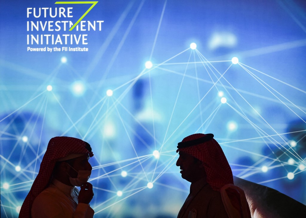Delegates speak together as they attend the fourth edition of the Future Investment Initiative (FII) conference at the capital Riyadh's Ritz-Carlton hotel on January 27, 2021