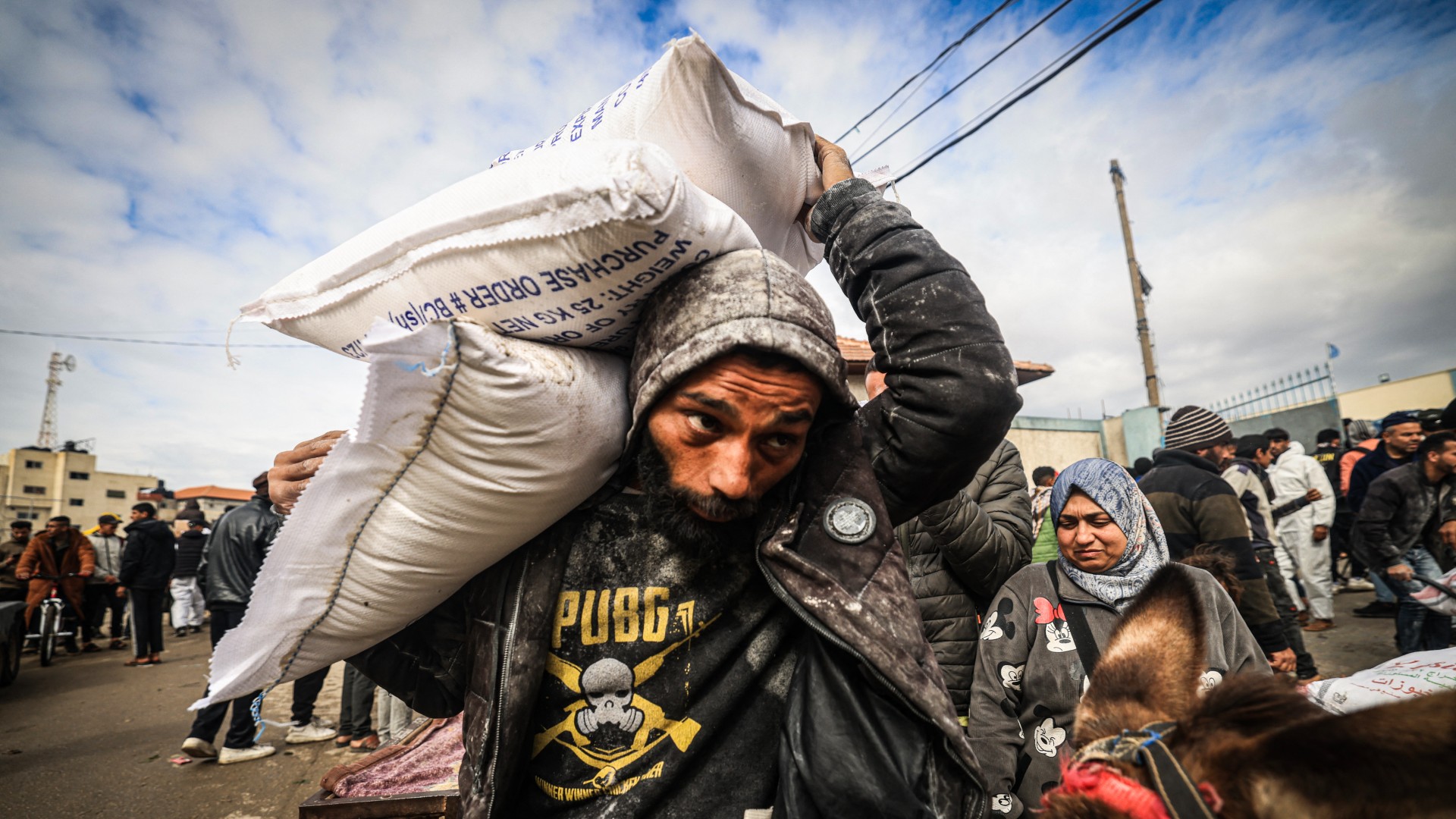 Displaced Palestinians receive food aid in Rafah in the southern Gaza Strip on 28 January (AFP)