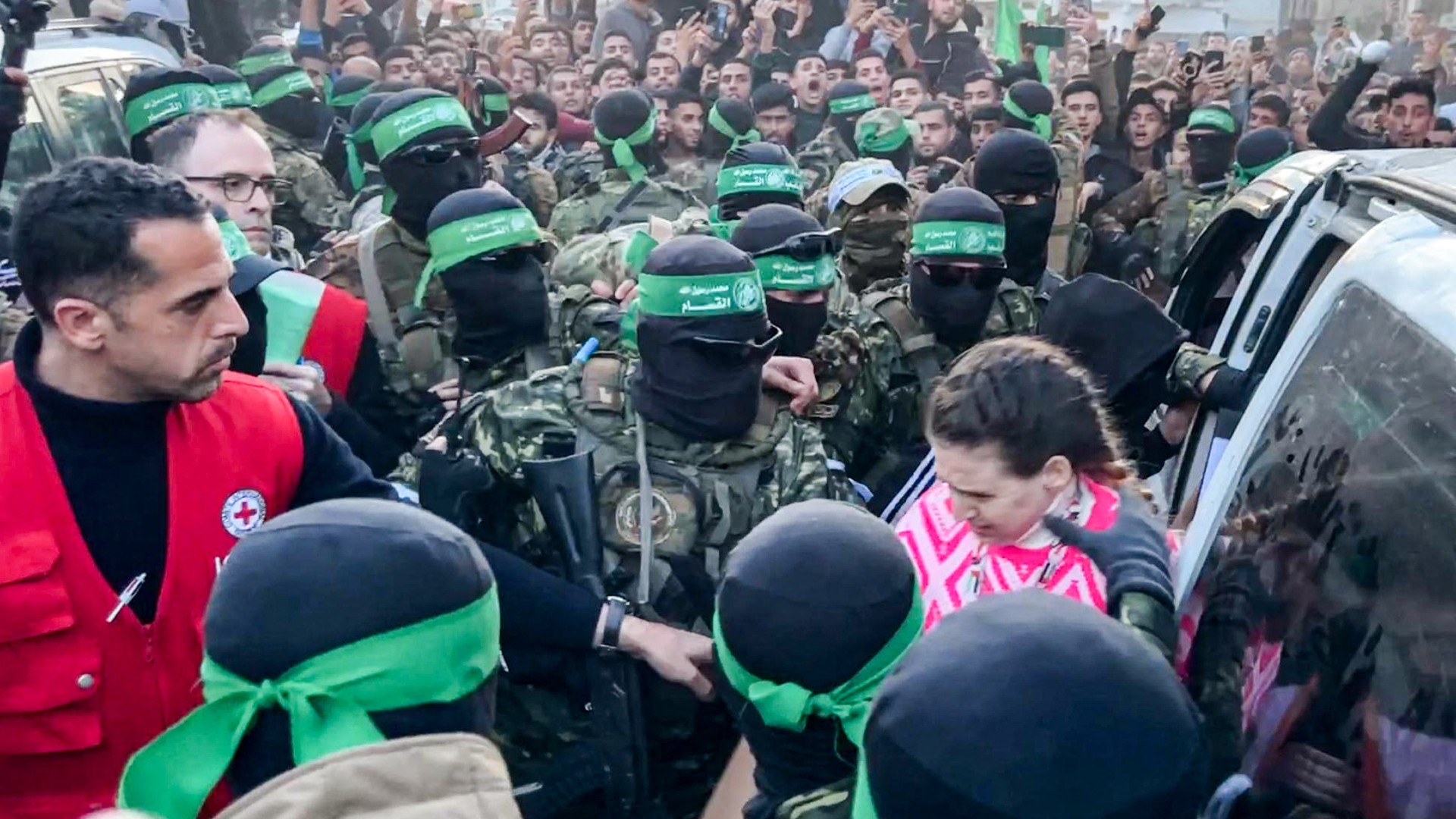 Israeli captives are handed over to the Red Cross during the exchange operation in Gaza City on 19 January (AFP)