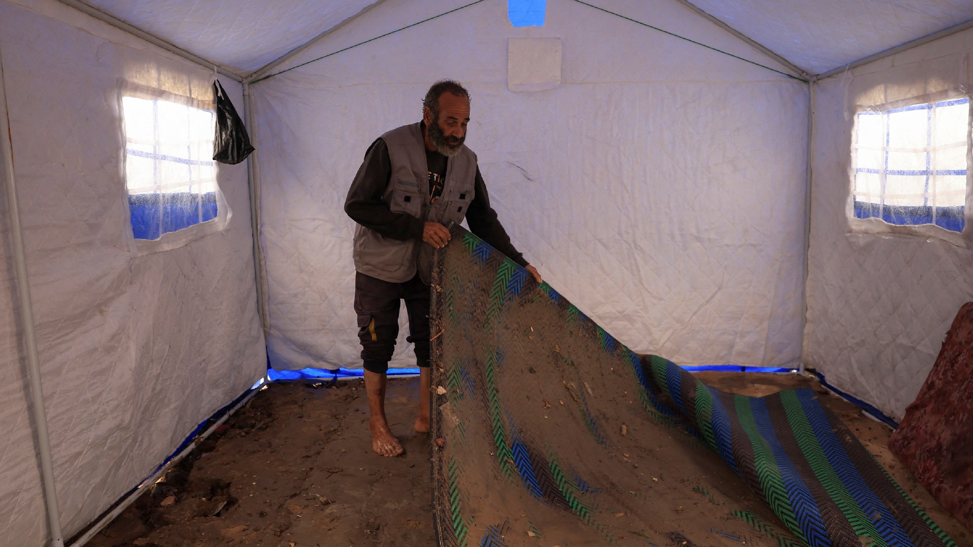 Palestinians shelter in tents during rain in Gaza City