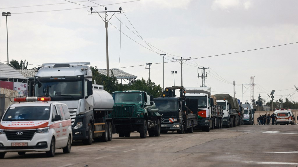 An aid convoy enters the Gaza Strip through the Rafah crossing with Egypt on 20 November 2023 (Mohammed Abed/AFP)