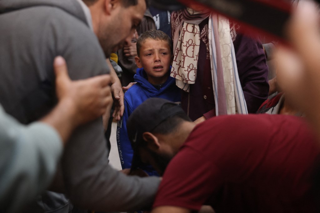 Displaced Palestinians mourn during the funeral of people that were reportedly killed by an Israeli strike, at the Nasser Hospital in Khan Yunis, in the southern Gaza Strip on March 17, 2026.