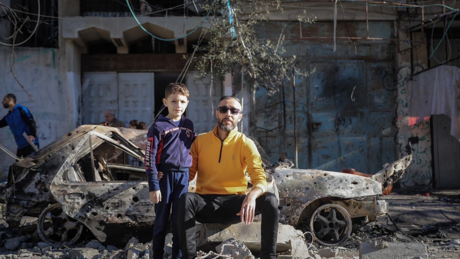 The author is pictured with his son during Israel’s war on Gaza, when their house was still standing (Submitted photo)