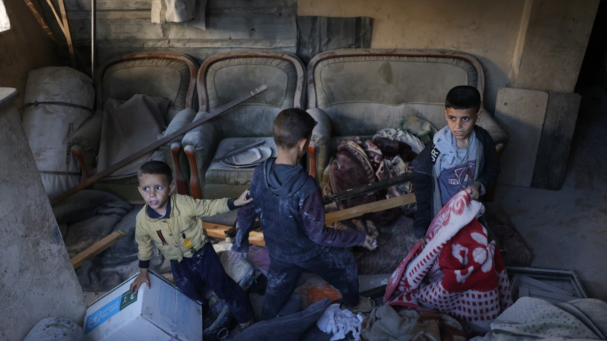 Children search for salvageable items following an Israeli strike that hit the home of a Palestinian family in Jabalia in the northern Gaza Strip on May 23, 2025. (Bashar TALEB / AFP)