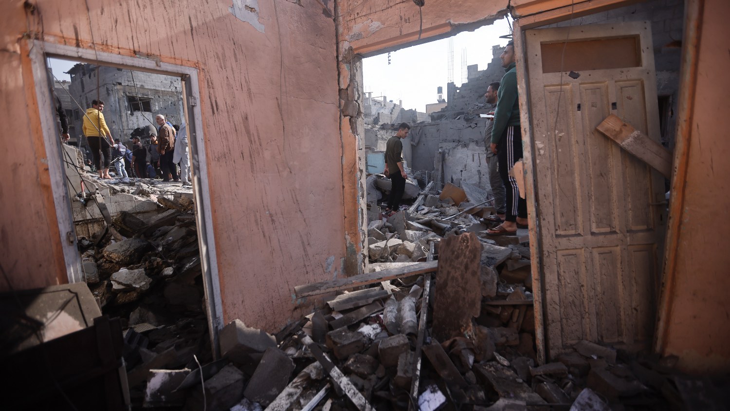 Palestinians look at destruction after the Israeli bombing In Khan Younis refugee camp in Gaza Strip on 1 December 2023.