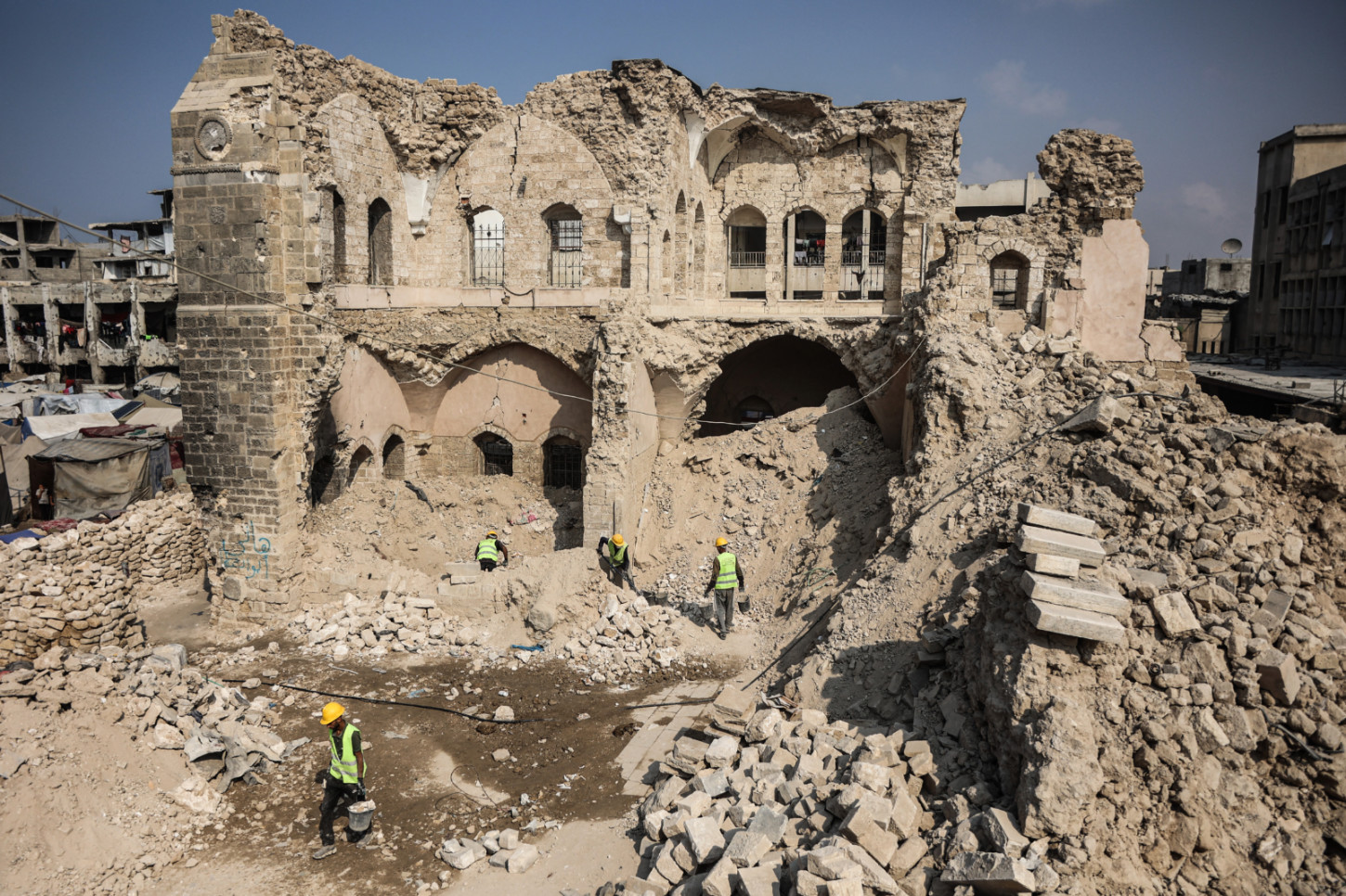 Workers start the rehabilitation on what remains of the Pasha Palace Museum (Omar al-Qatta/AFP) 