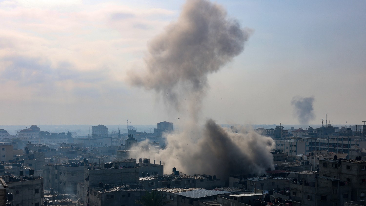 A plume of smoke rises during an Israeli strike on the Rafah refugee camp in the southern Gaza Strip on 1 December 2023.