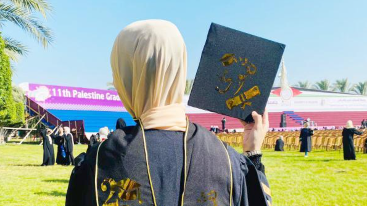 The author holds her graduation cap at the final Tawjihi ceremony before the Gaza genocide began in 2023 (Photo submitted by Taqwa Ahmed al-Wawi)