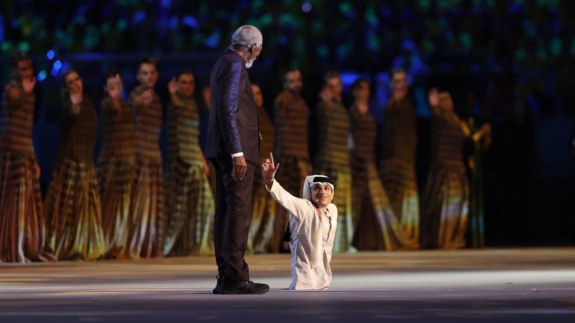Actor Morgan Freeman and Qatari YouTuber Ghanim al Muftah take part in the opening ceremony ahead of the 2022 World Cup (AFP)