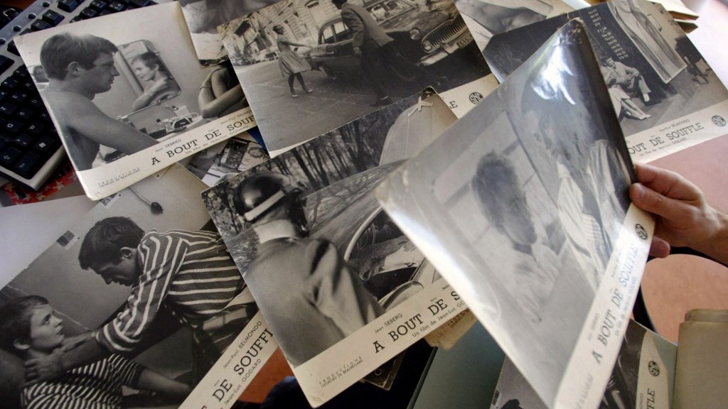 An employee classifies photos from one of Godard’s films at a cinema archive in the suburbs of Toulouse, France, in September 2004 (AFP)