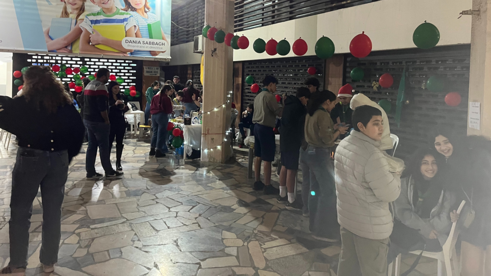 Hadat's residents buy food and accessories at the local scouts' Christmas party on 23 December 2024 (Nader Durgham/MEE)