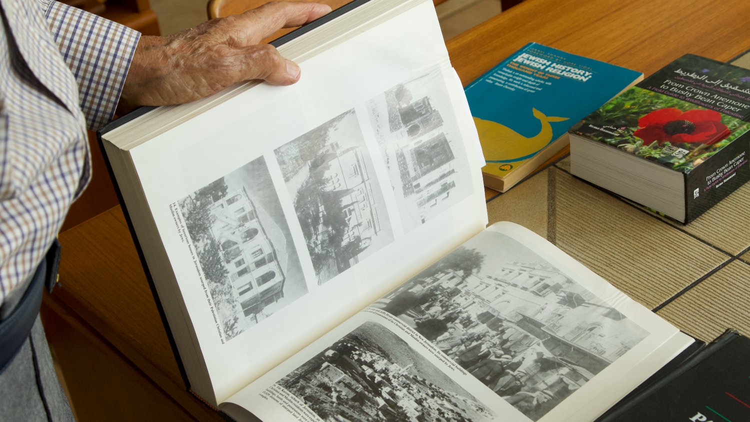 Hassan Hammami looks through the Encyclopedia Palestinnica.