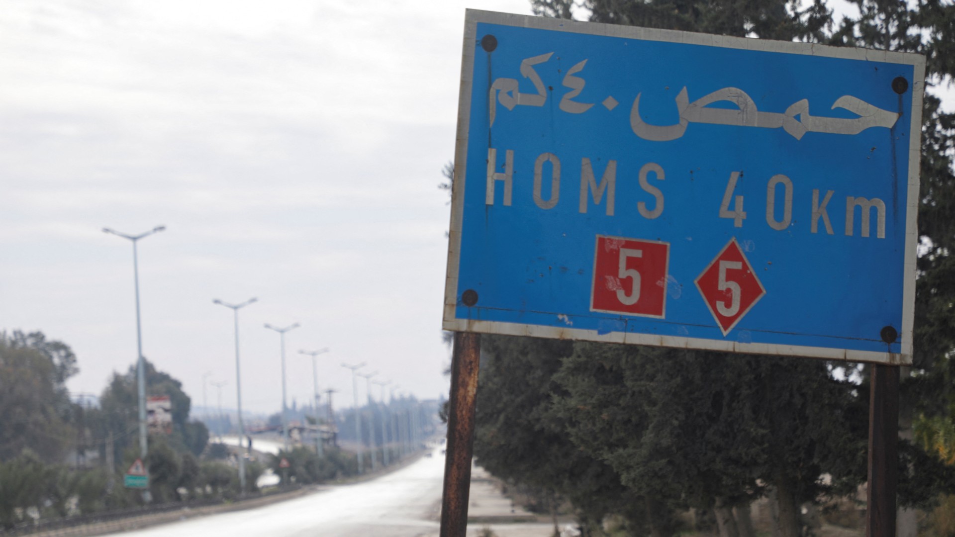 A view of a sign on a road to Hama (Reuters/Mahmoud Hasano)
