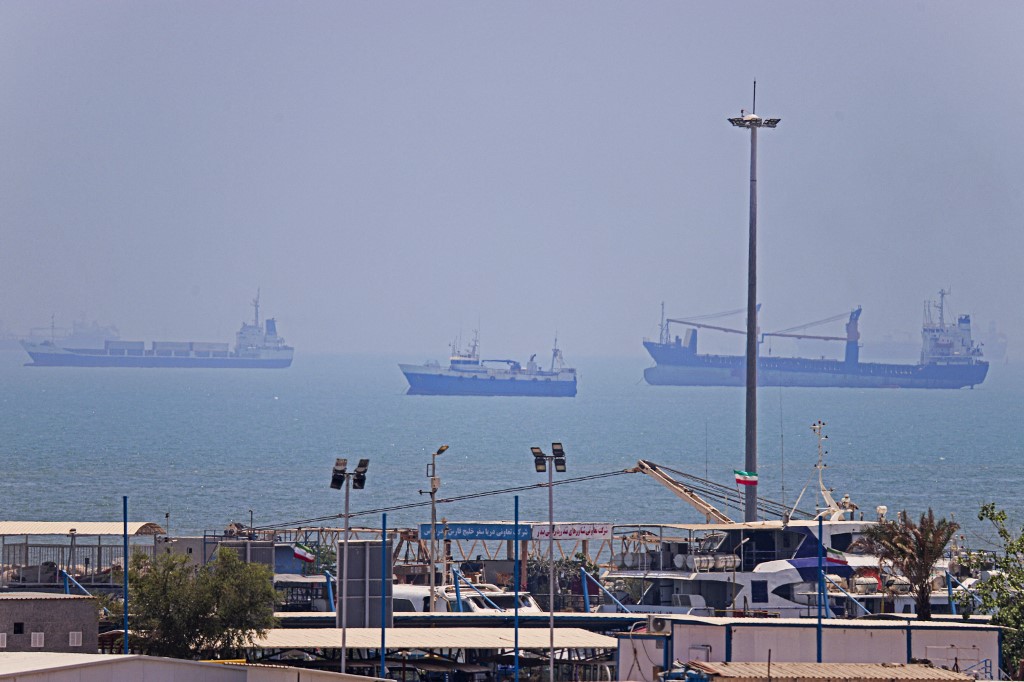 In this picture obtained from Iran's ISNA news agency on June 18, 2026, vessels are seen anchored in Bandar Abbas along the Strait of Hormuz. Oil prices tumbled after Trump and his Iranian counterpart separately signed their accord to end the Middle East war, with the Strait of Hormuz to reopen but two months of negotiations lying ahead. AMIRHOSSEIN KHORGOOEI / ISNA / AFP