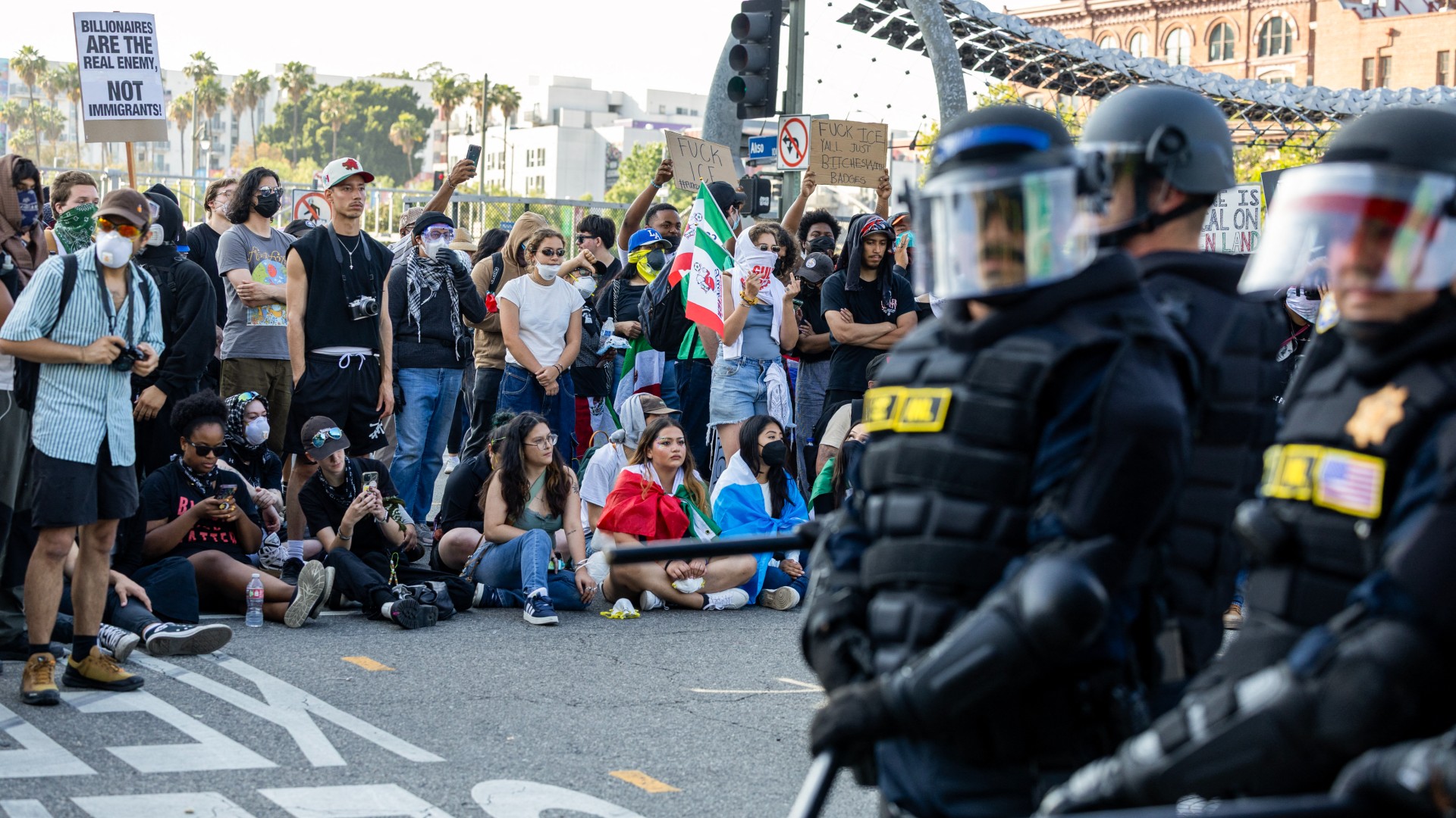 Protesters clash with law enforcement in the streets surrounding the federal building during a protest following federal immigration operations in Los Angeles, California, on June 8, 2025. Demonstrators torched cars and scuffled with security forces in Los Angeles on June 8, as police kept protestors away from the National Guard troops President Donald Trump sent to the streets of the second biggest US city. RINGO CHIU / AFP