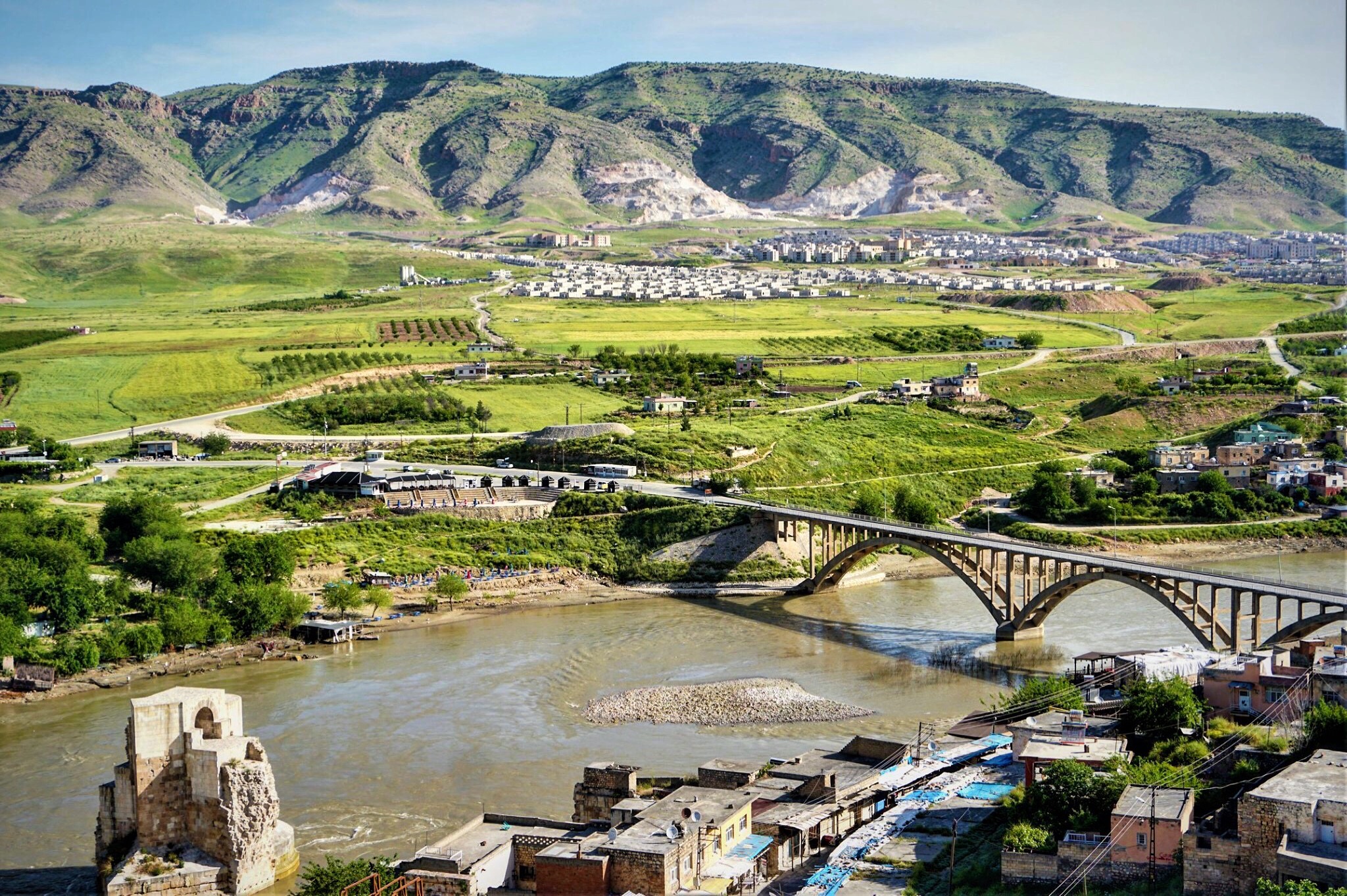 A resident stands on the roof of her house located on the bank of the Tigris river in Hasankeyf, in Turkey's Kurdish-majority southeast, on December 13, 2018, during the construction of the Ilisu dam (AFP)