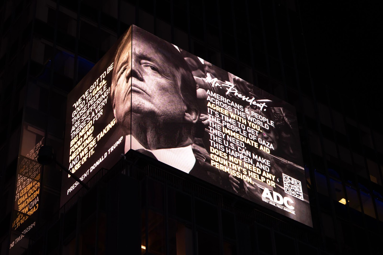 A billboard erected by the ADC in Times Square on 12 May 2025 shows President Donald Trump's face and a demand that he allow unconditional aid into Gaza, based on his own pledge to help.