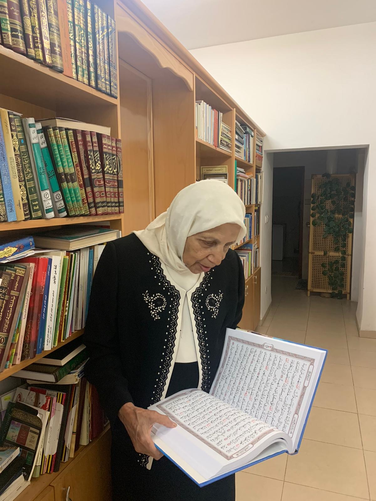 Jihad Mohammad Battu holding reading from the Quran (MEE/ 
