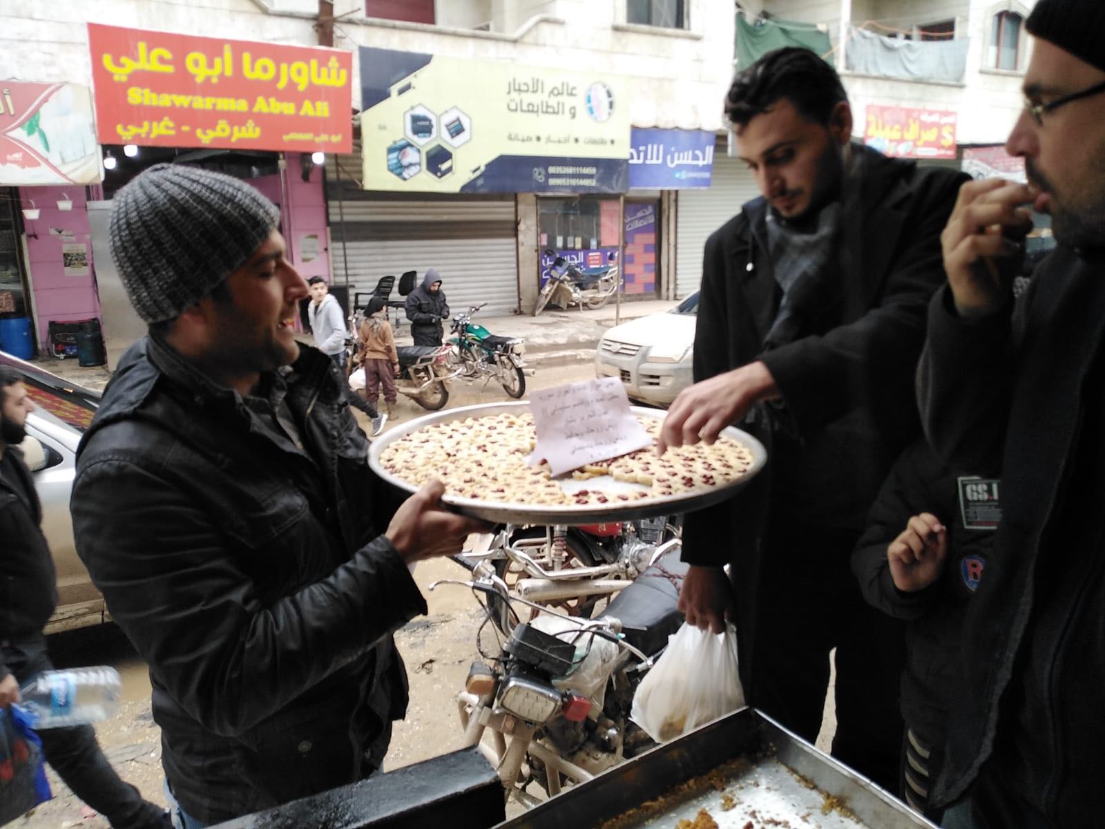 Syrians in Idlib eat sweets to celebrate the news of Soleimani's death (MEE/Sulaiman Abdelqader)