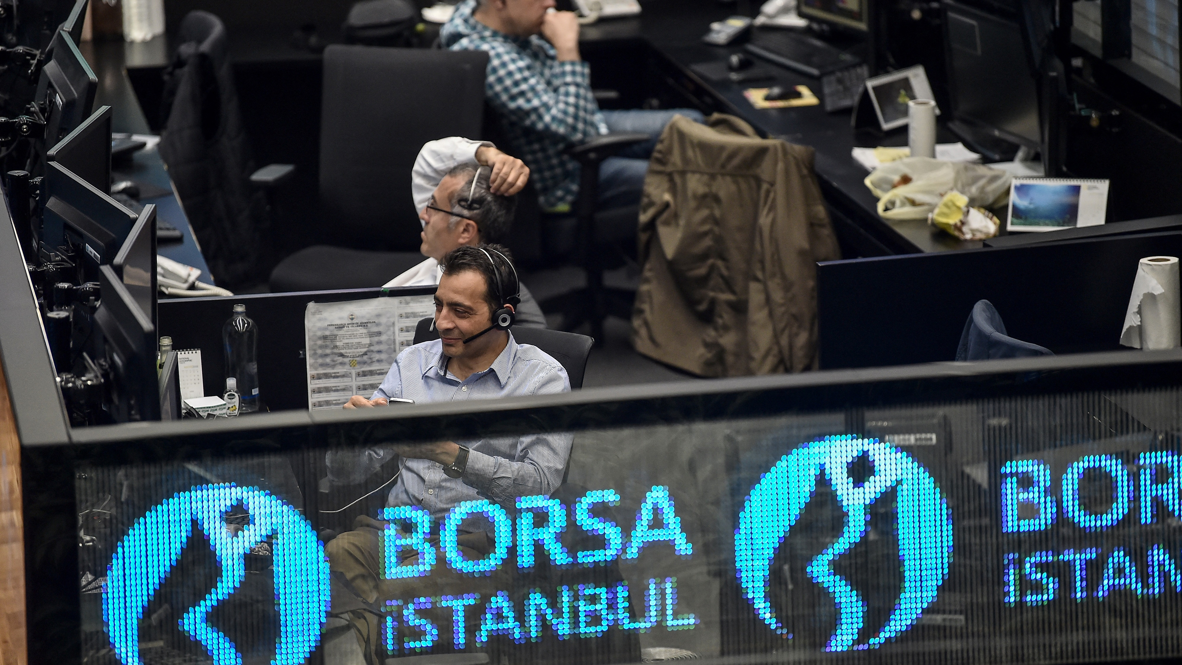 Traders work at their desks on the floor of Turkey's Borsa Istanbul, on 22 May 2018.