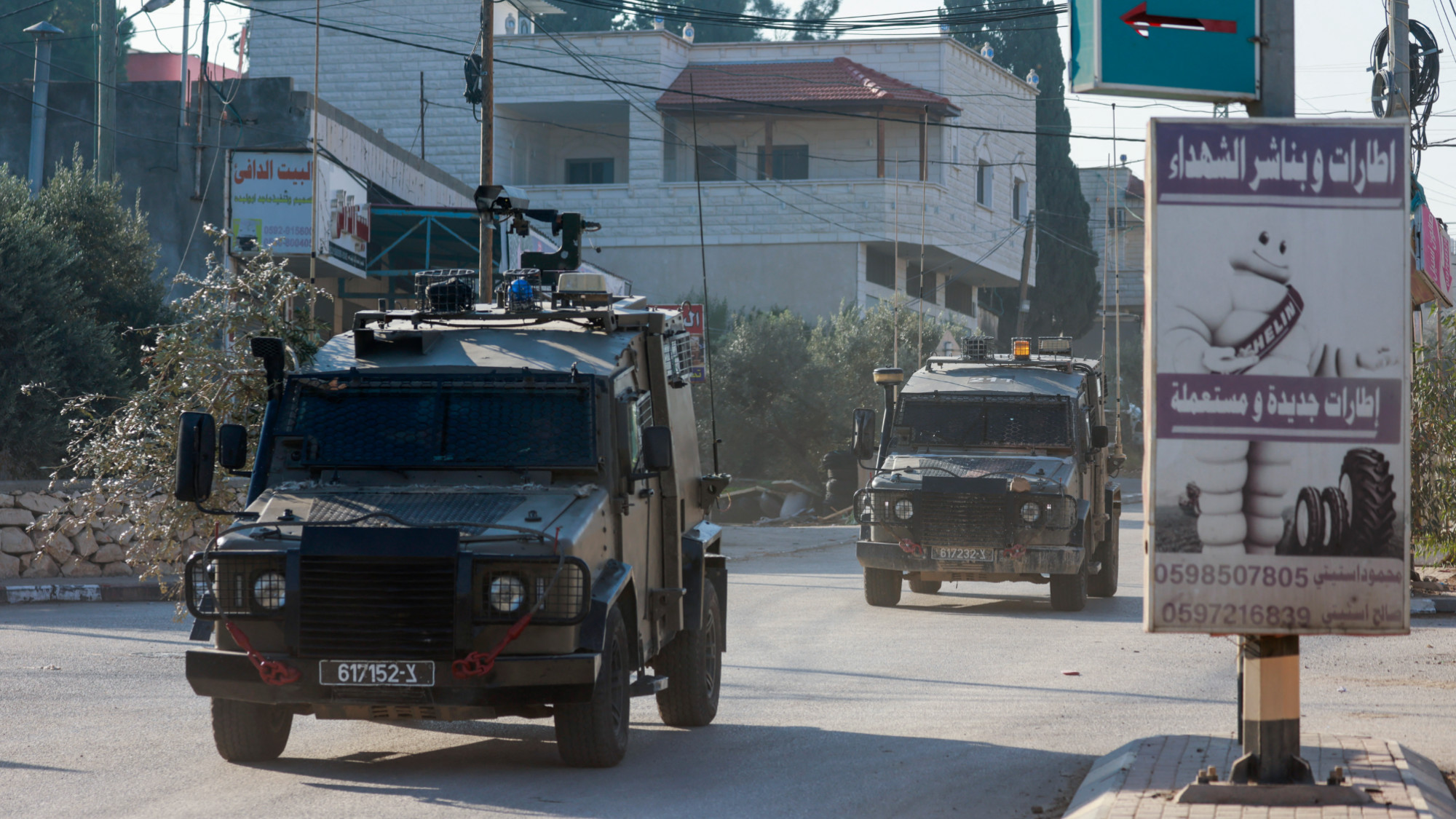 Israeli army vehicles drive down a road during a raid in Qabatiya, south of Jenin city in the occupied West Bank on 5 November 2024 (Reuters/Jaafar Ashtiyeh)