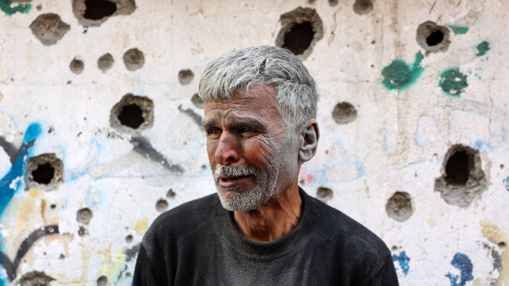 An elderly Palestinian man reacts as he stands in front of a building hit by an Israeli strike, in Gaza City's eastern neighbourhood of Shujaiya on 10 April 2025 (AFP/Omar al-Qattaa)