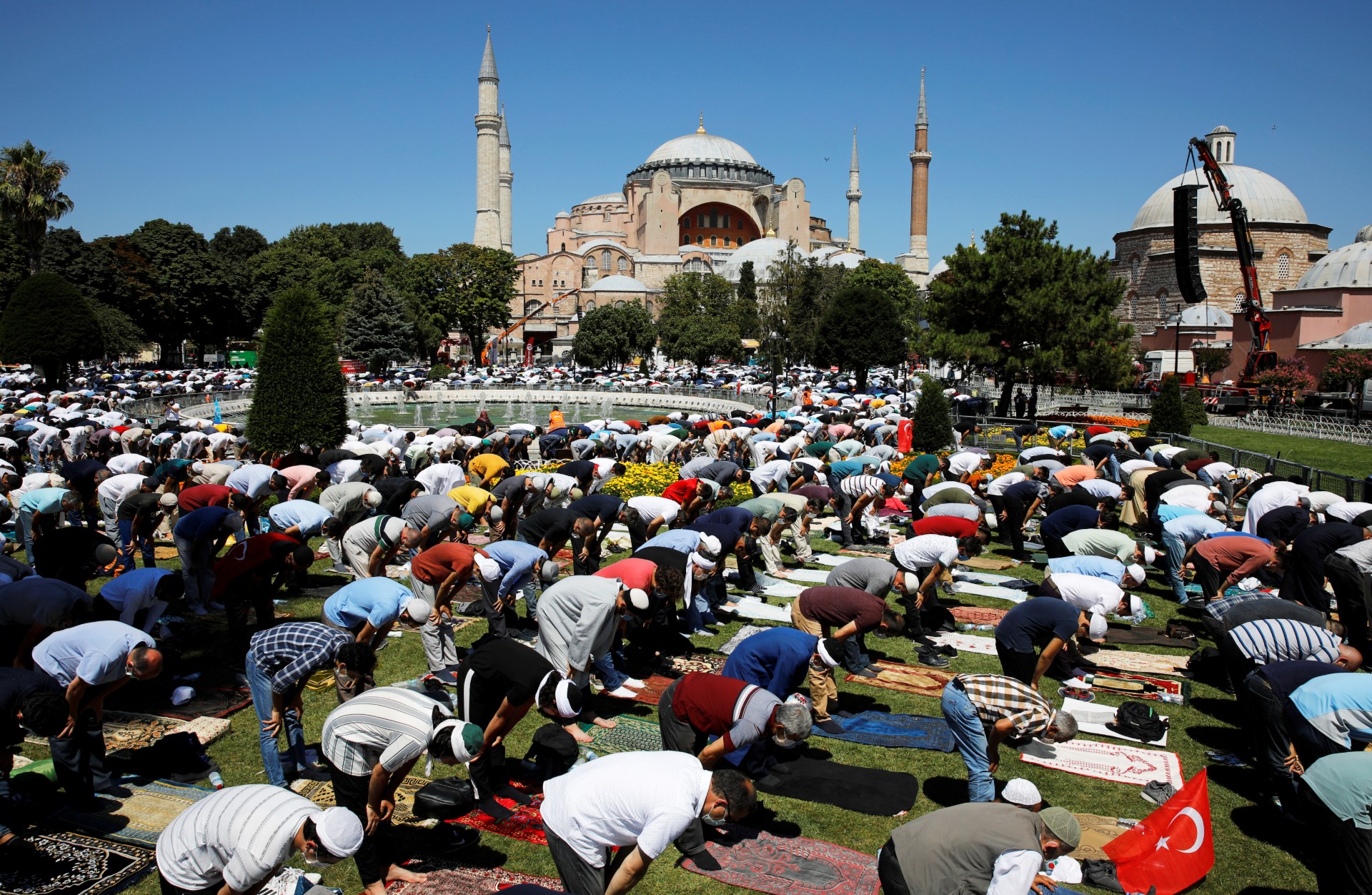 Muslims attend Friday prayers outside Hagia Sophia Grand Mosque, for the first time after it was once again declared a mosque after 86 years, in Istanbul (Reuters)