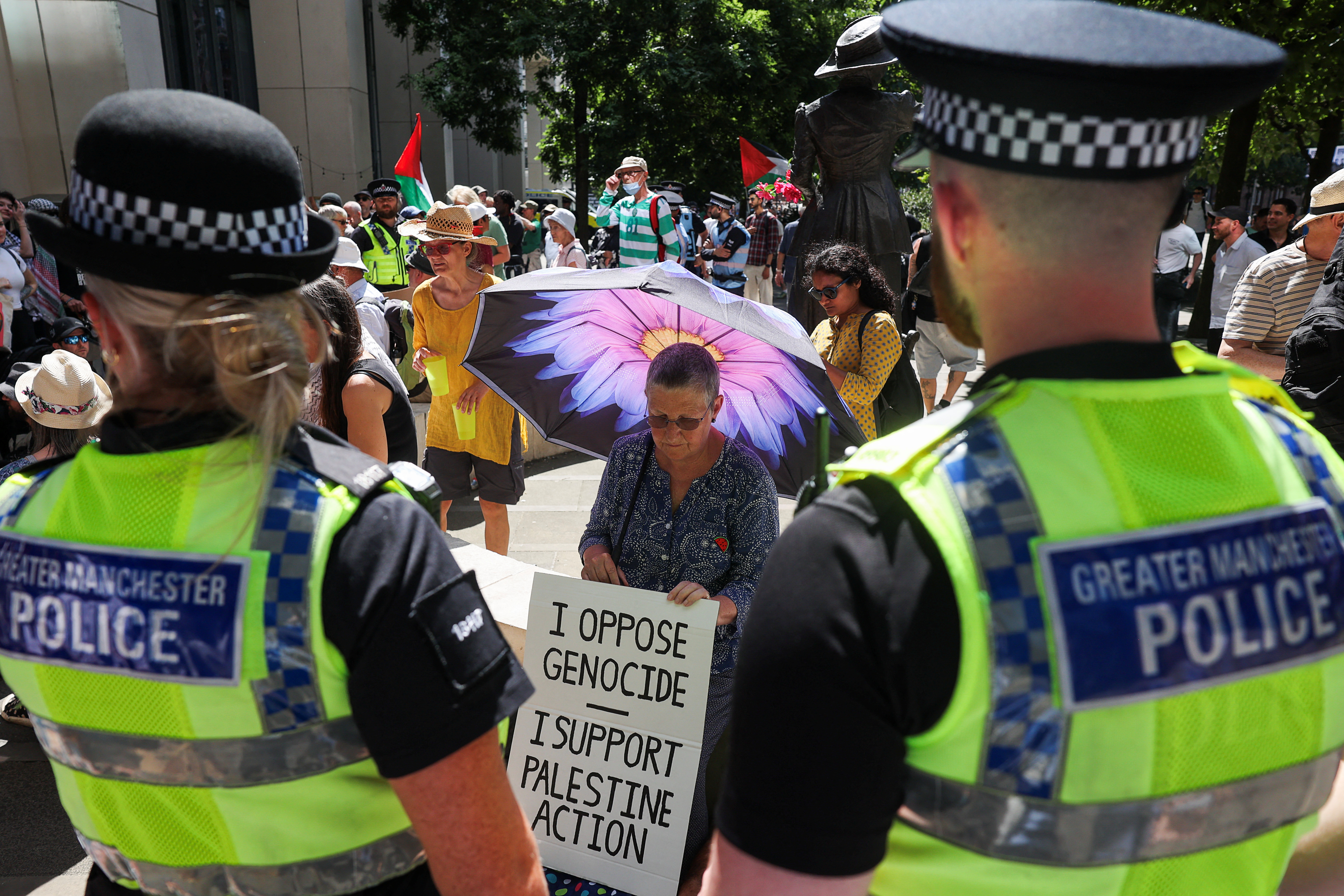 A demonstrator sits with a sign, during a protest calling for the de-proscription of the Palestine Action group, at St Peter's Square in Manchester, Britain, 12 July, 2025. (Reuters)