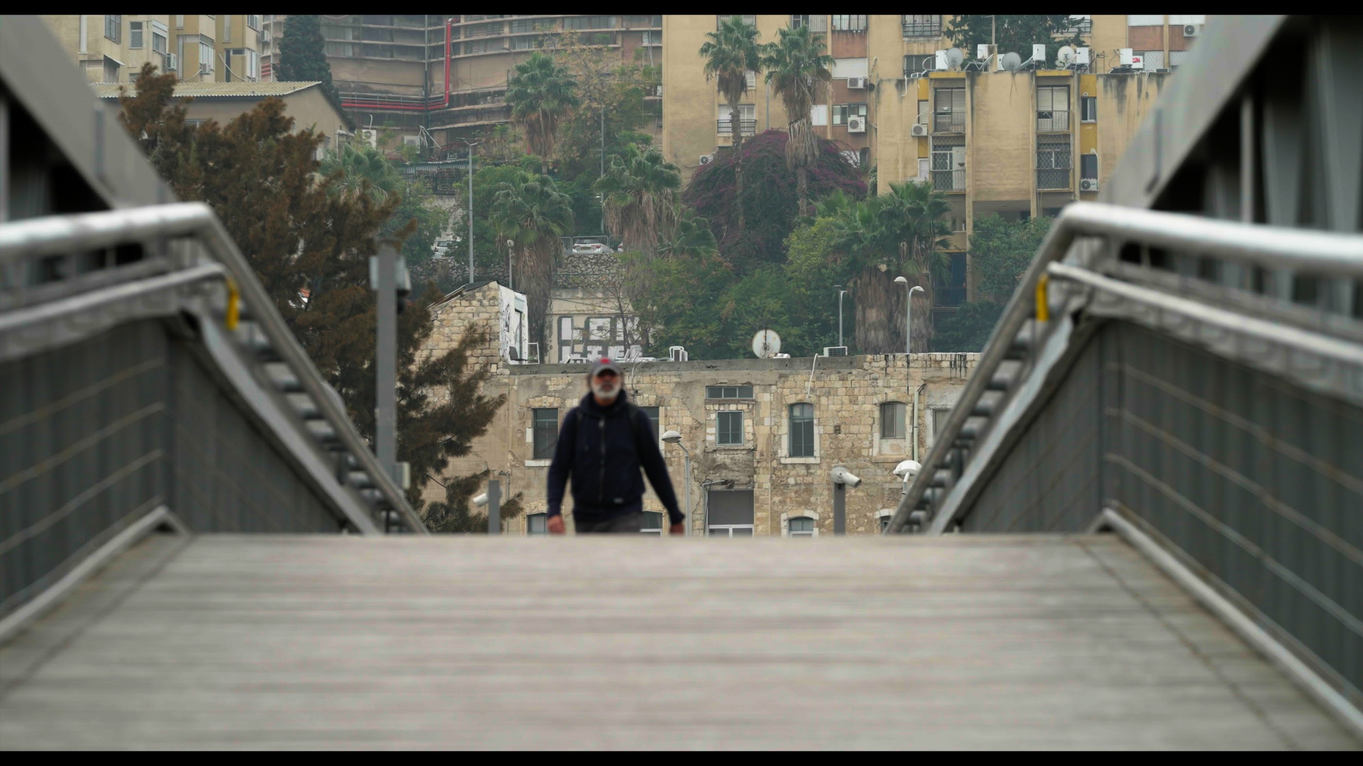 Filmmaker Nizar Hassan walks along the streets of Haifa in his latest film to uncover the city's Palestinian history (Provided)