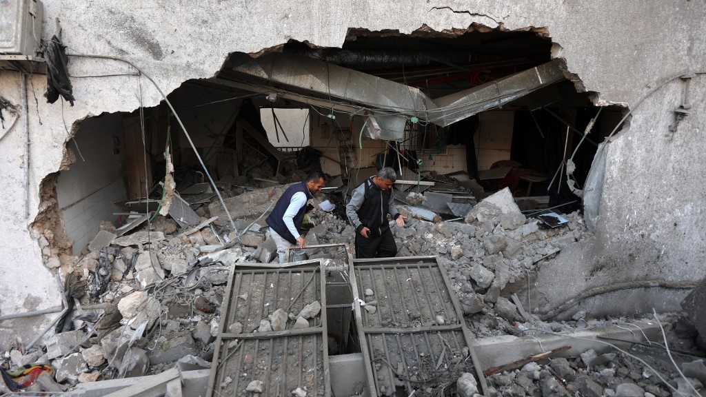 People inspect the destruction following an Israeli strike on al-Ahli al-Arabi Baptist Hospital in Gaza City on 13 April 2025 (Omar Al-Qattaa/AFP)