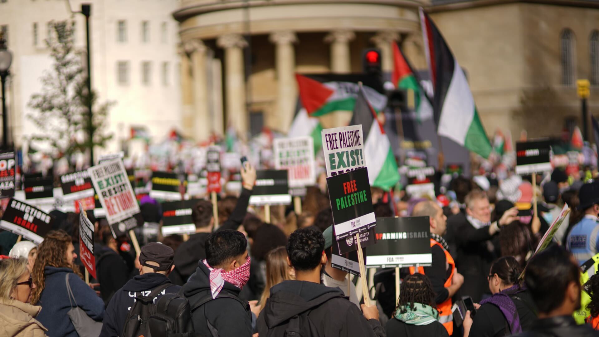 Thousand of protesters with placards and Palestinian flags take part in a 