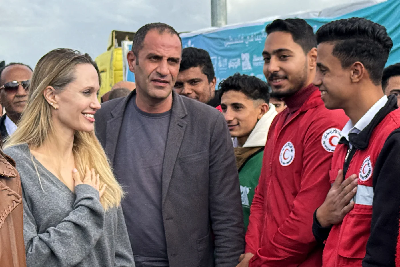 American actor and former UN special envoy Angelina Jolie greets an employee of the Egyptian Red Crescent at the Egyptian Rafah border crossing to Gaza on 2 January 2026 (AFP)