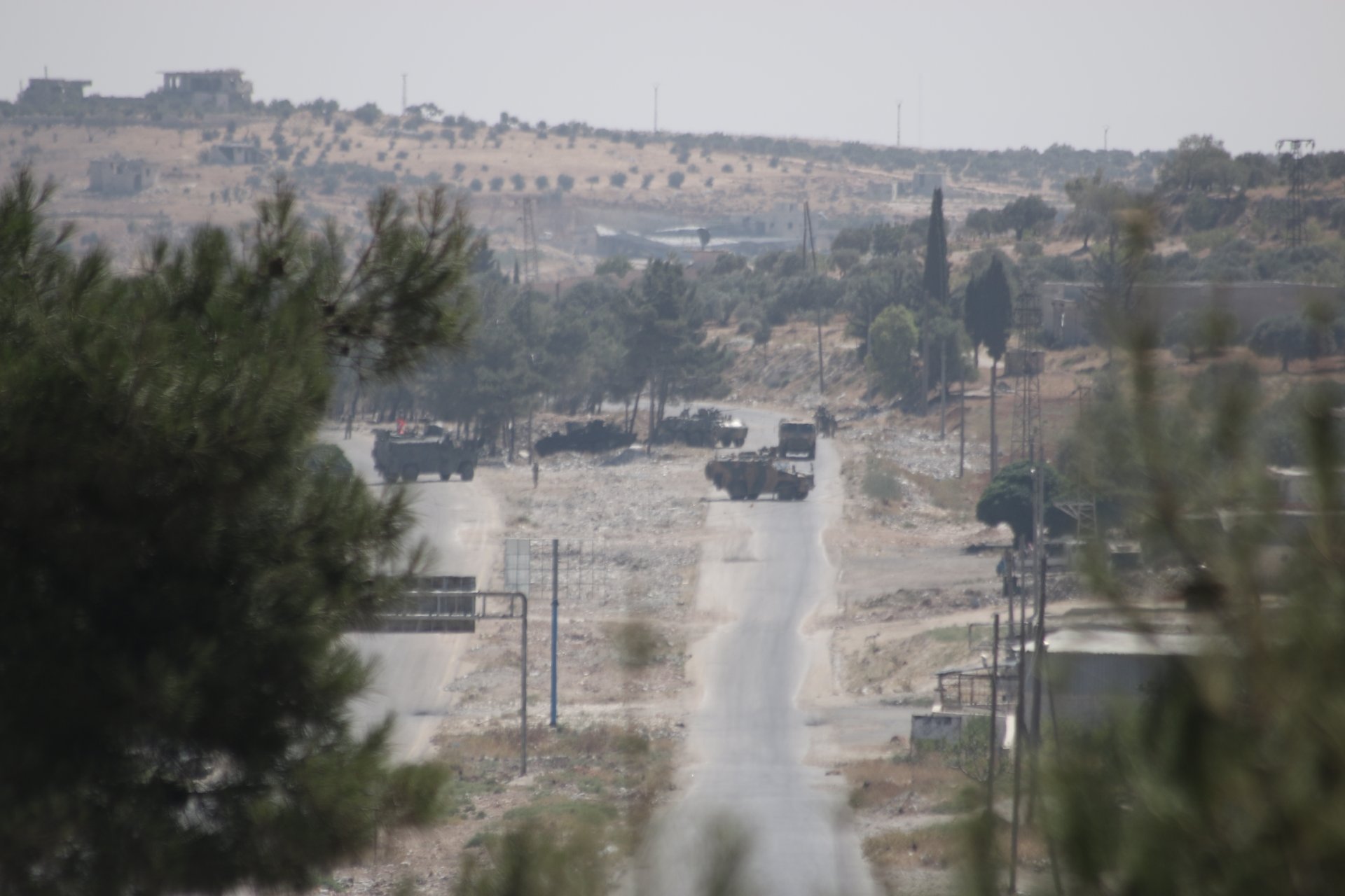 Turkish vehicles attempt to retrieve a Russian vehicle on the M4 highway after bomb attack (MEE/Ahmad Fallaha)
