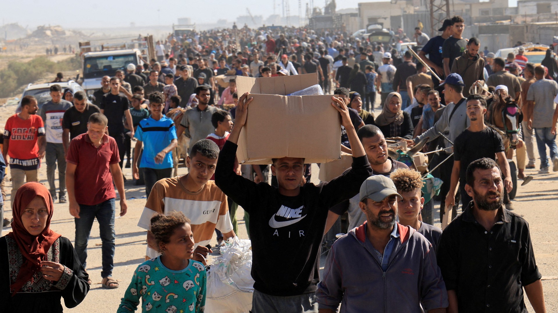 Palestinians seeking aid gather near an aid distribution site run by the US-backed Gaza Humanitarian Foundation, in Rafah, in the southern Gaza Strip, 27 May 2025 (Reuters)