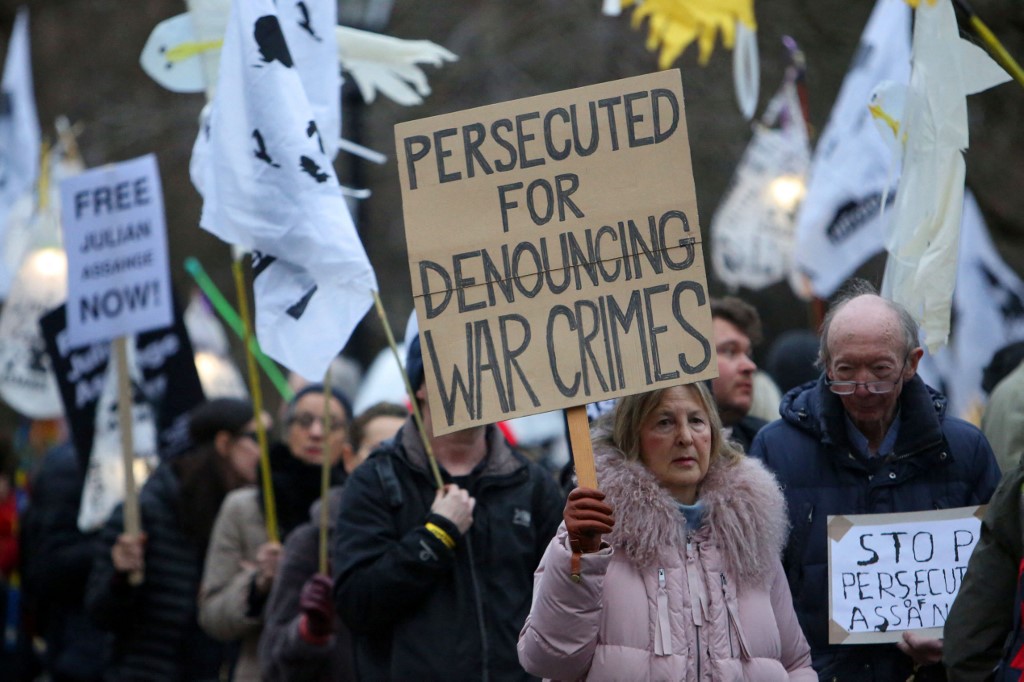 Supporters of WikiLeaks founder Julian Assange take part in a 'Night Carnival for Assange' march in London on 11 February 2023 (AFP)