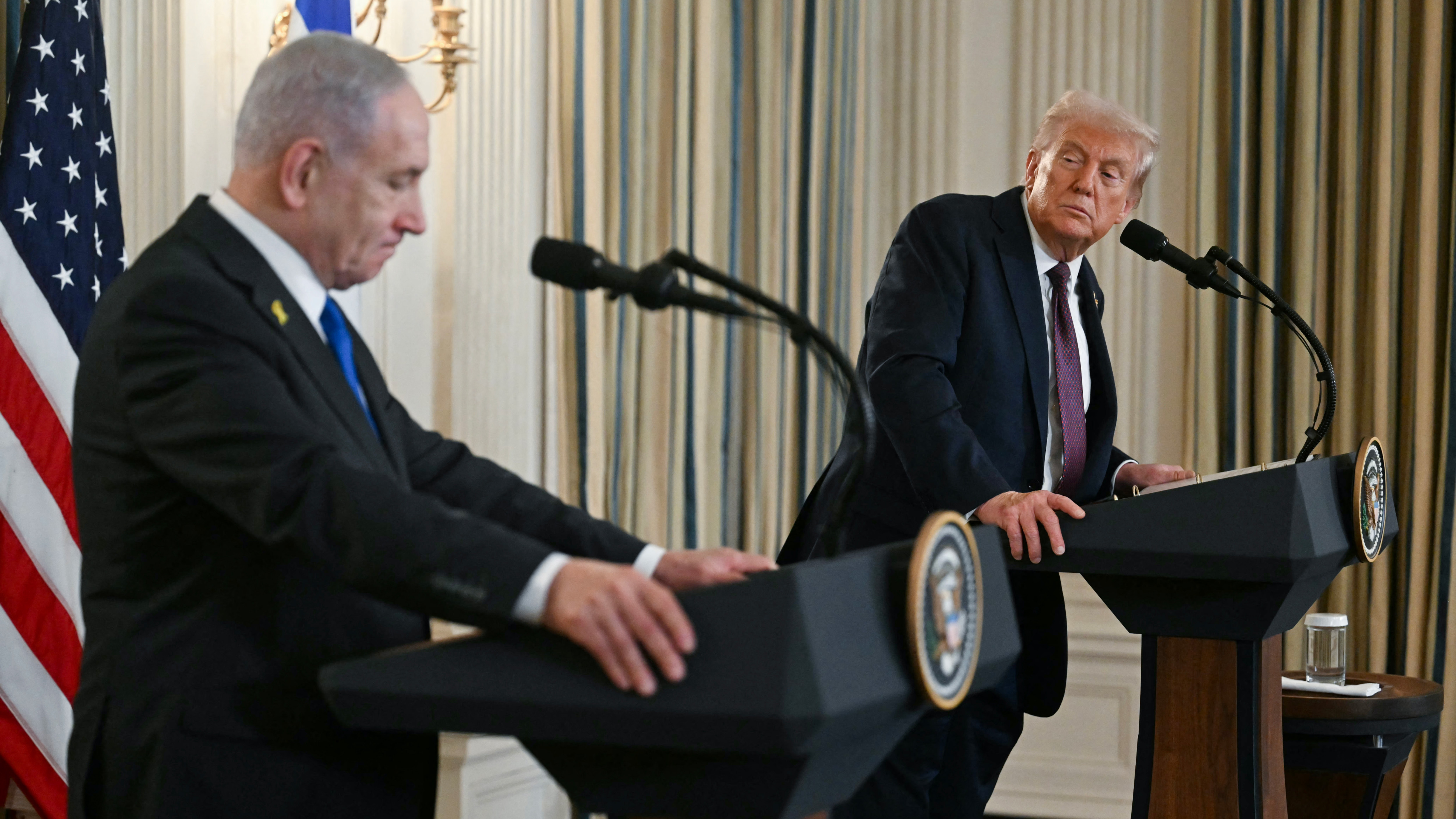 Benjamin Netanyahu and Donald Trump speak at a White House news conference unveiling the plan on 29 September 2025 (AFP)
