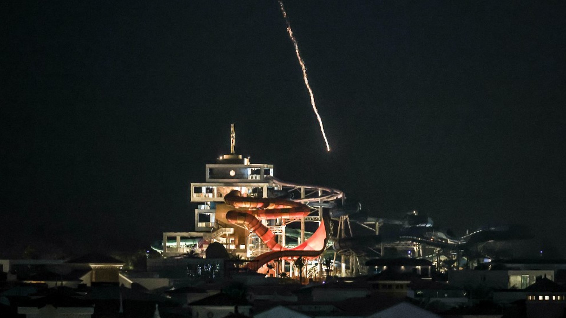 An intercepted projectile falls into the sea near Dubai's Palm Jumeirah archipelago on 1 March 2026 (AFP)