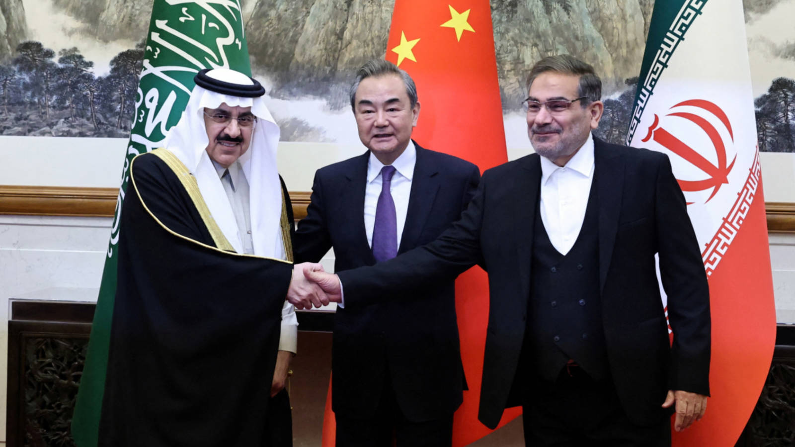 Ali Shamkani, right, signs an agreement with Saudi Arabia in Beijing in March last year (AFP)
