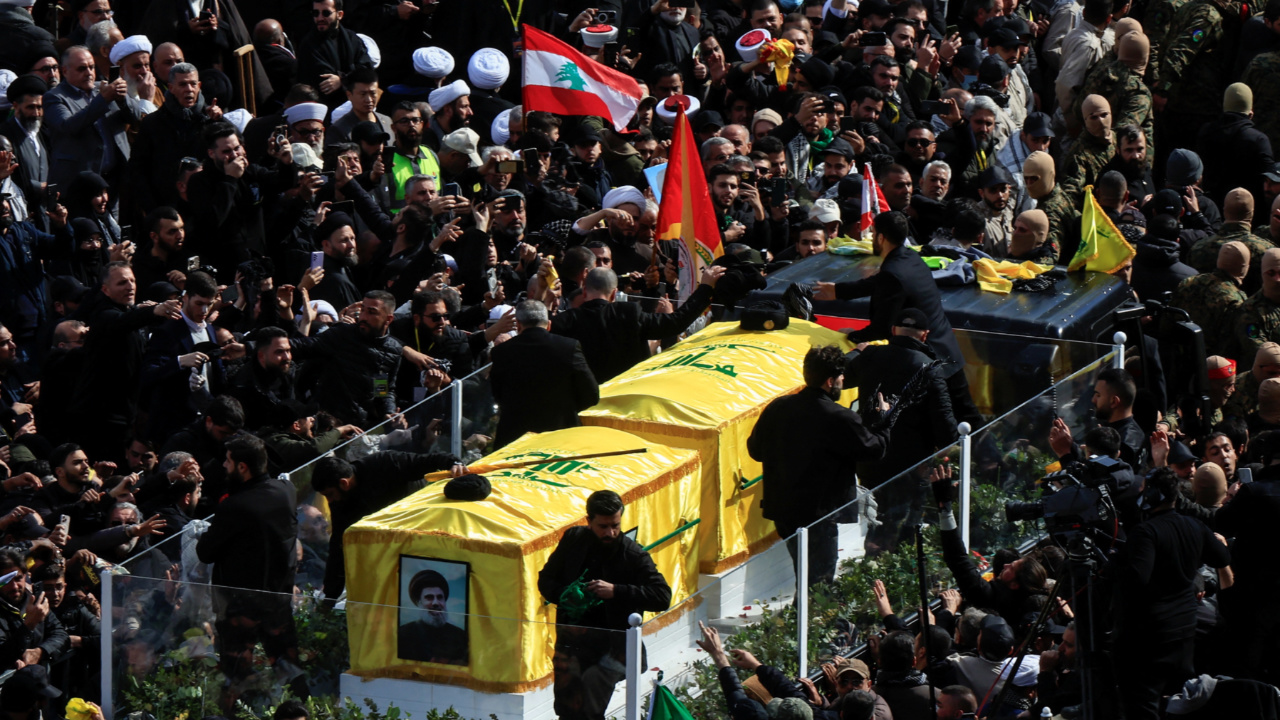 A vehicle carries the coffins of former Hezbollah leaders Hassan Nasrallah and Hashem Safieddine (Reuters)