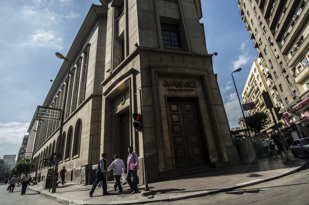People walk past Egypt’s Central Bank in Cairo in 2016 (AFP)