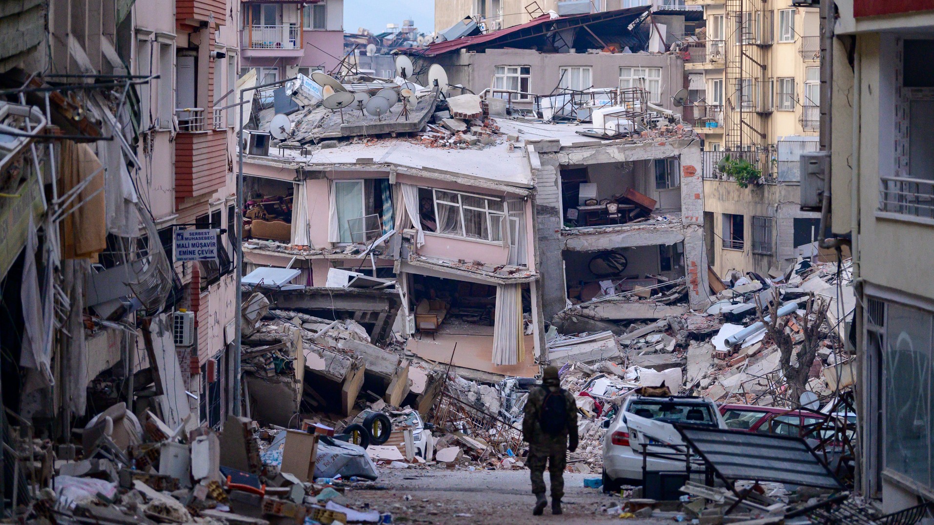 A soldier walks among destroyed buildings in southeast Turkey's Hatay province on 12 February 2023.
