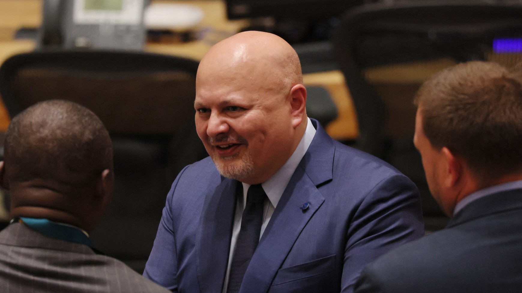 In this file photo, Prosecutor of the International Criminal Court Karim Khan greets people as he arrives for a United Nations Security Council meeting at UN headquarters in New York City, on 13 July 2023 (AFP)