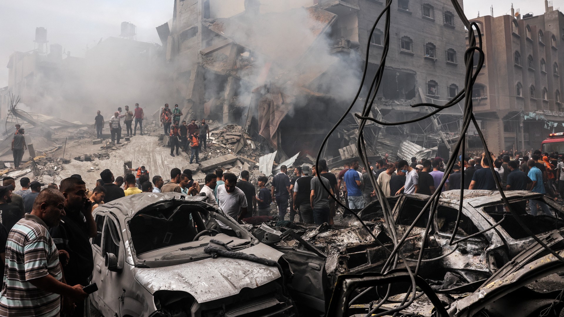 Palestinians search for survivors after an Israeli air strike on buildings in Jabalia refugee camp in the Gaza Strip, on 9 October 2023 (AFP)