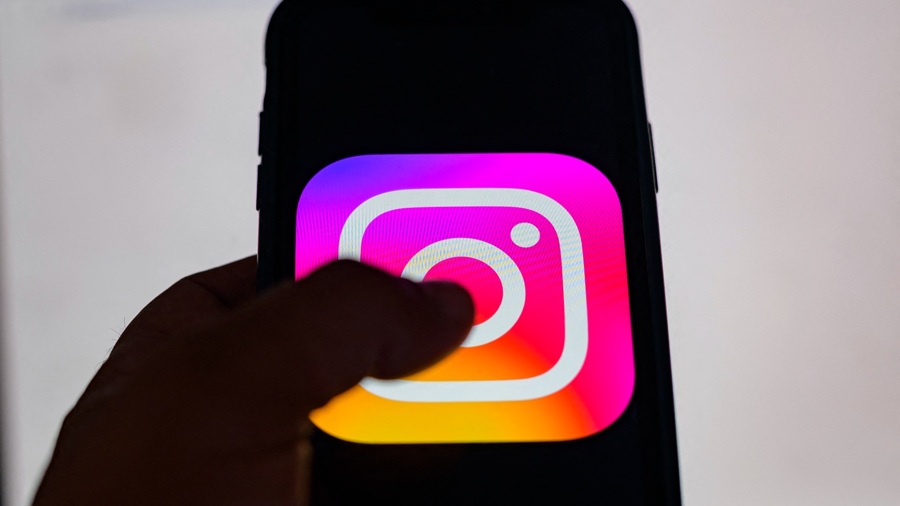 The logo of the social network Instagram on a smartphone (AFP)