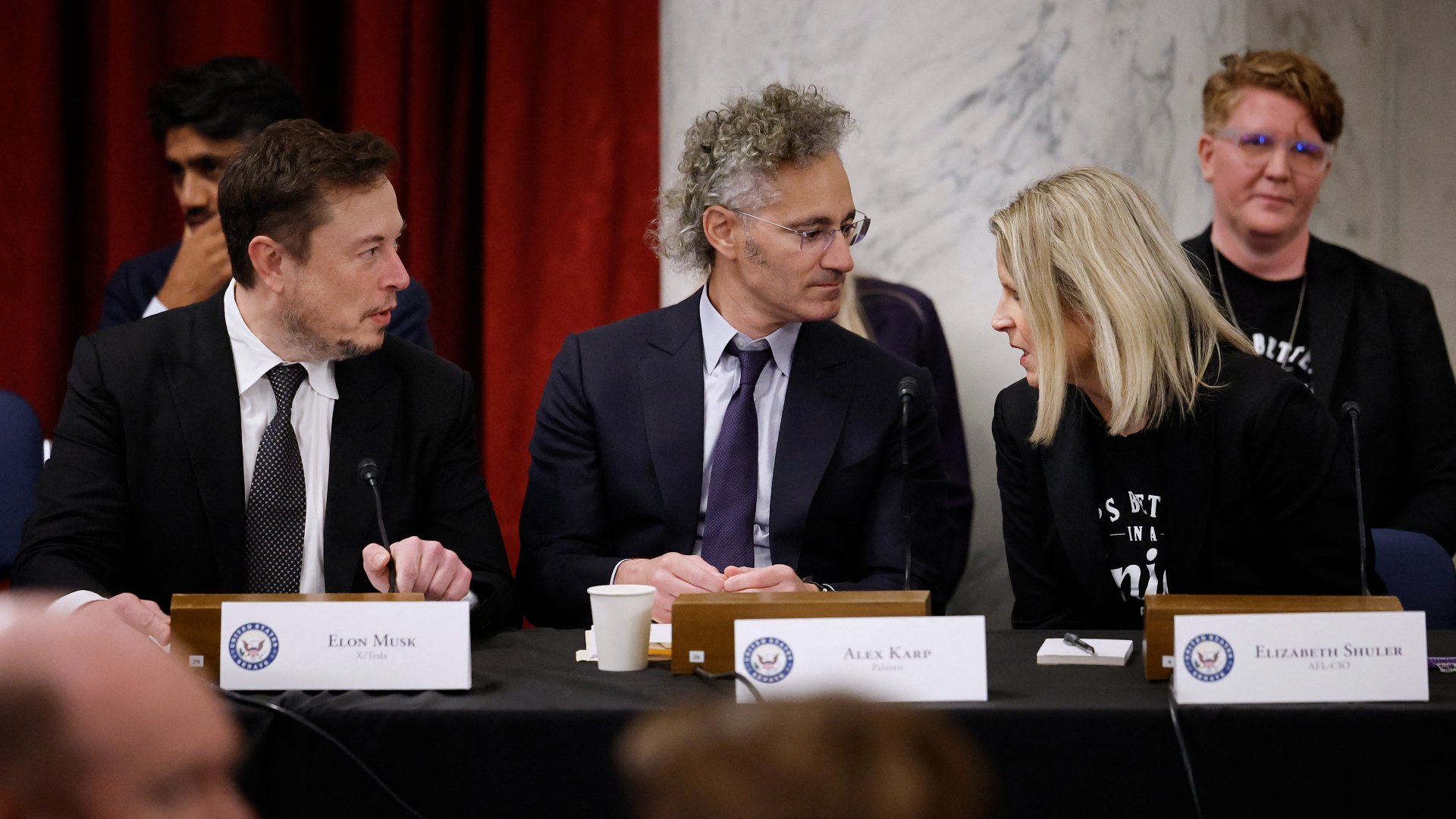 Alex Karp (C), pictured at an AI forum in Washington in September, says he is proud of Palantir's support for Israel