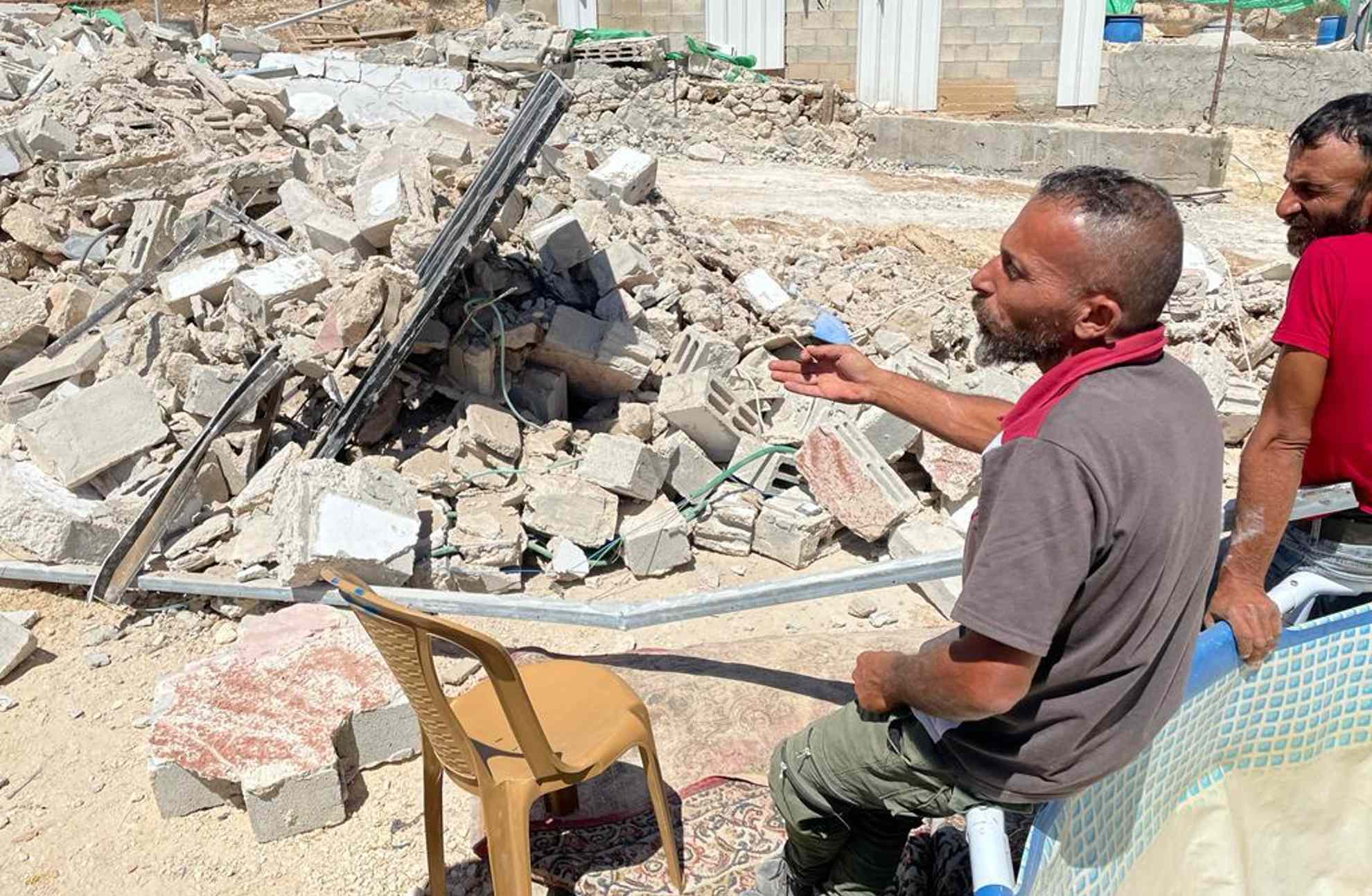 Asharaf Mahmoud Amour inspects the ruins of his demolished home in the West Bank village of Letwani (David Hearst/MEE)