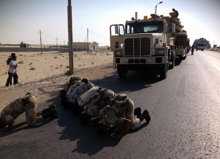 Egyptian soldiers pray as they are deployed in the northern Sinai town of Al-Arish in 2013 (AFP)