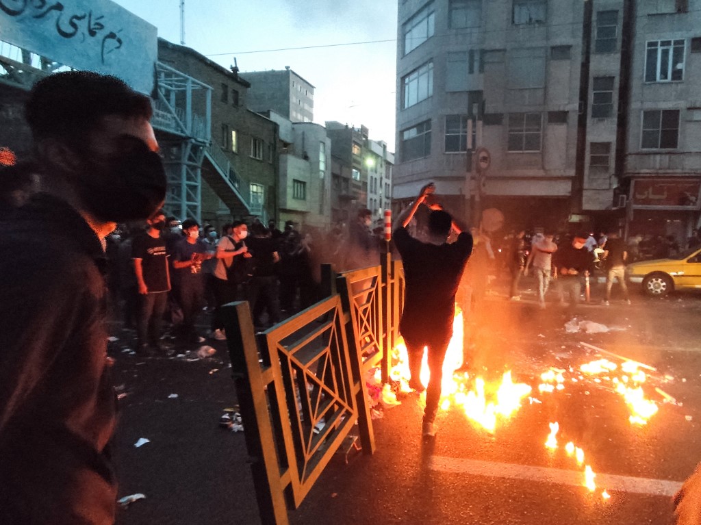 Iranians protest the death of Mahsa Amini in Tehran on 21 September 2022 (AFP)