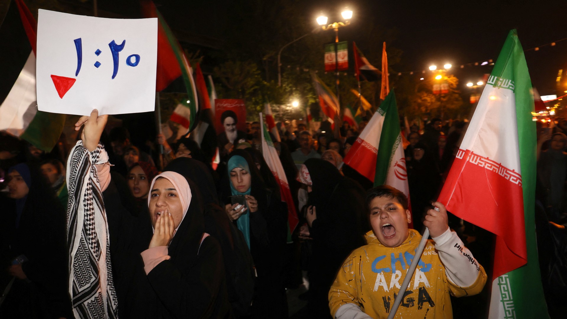 Iranians celebrate in the capital Tehran after the Islamic Republic launched retaliatory attacks against Israel on 14 April 2024 (Majid Asgaripour/WANA/Reuters)