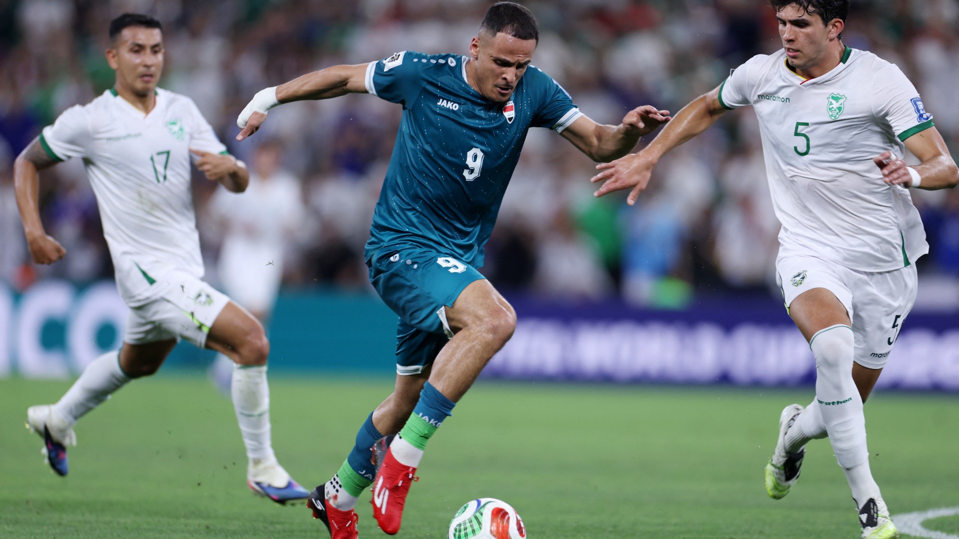 Iraq's forward Ali al-Hamadi dribbles the ball past Bolivia's defender Efrain Morales during their World Cup qualifier final playoff at the BBVA Stadium in Guadalupe, Nuevo Leon state, Mexico, on 31 March 2026 (AFP/Julio Cesar Aguilar)